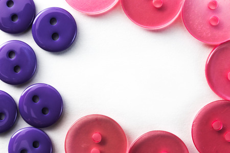 purple and pink buttons on a white background in macro
