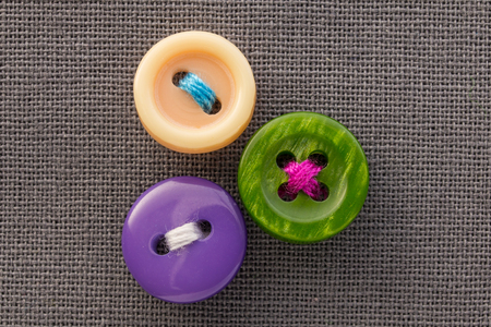 buttons on gray fabric in macroの写真素材