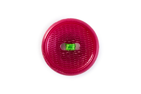 pink button with green thread on white backgroundの写真素材