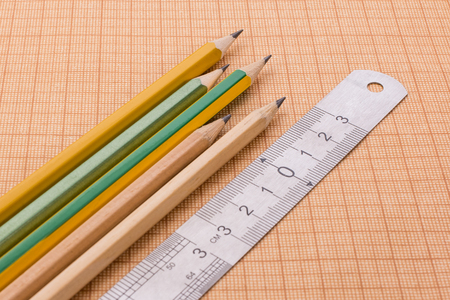pencils and ruler on graph paperの写真素材