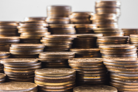 stacks of coins on a white backgroundの写真素材