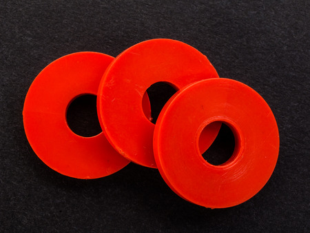 red plastic gaskets on a black backgroundの写真素材
