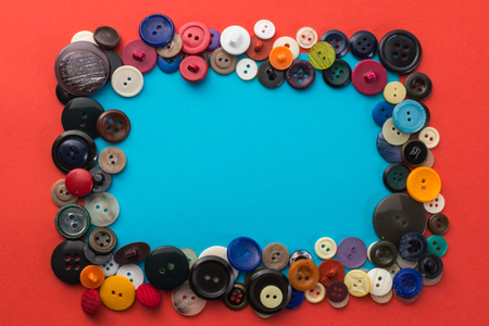 button and blue sheet of paper on a red backgroundの写真素材