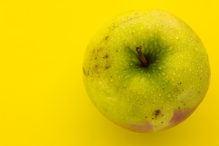 apple on a yellow backgroundの写真素材