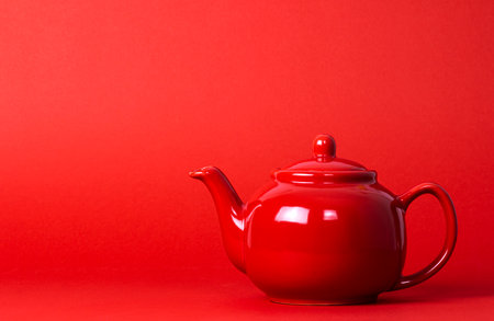 Red Teapot On A Red Backgroundの写真素材