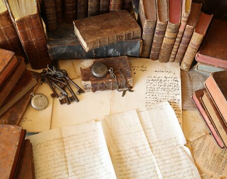Antique workspace with old books and handwriting.