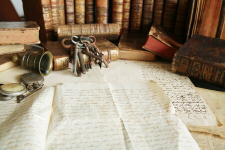 Antique workspace with old books and handwriting.