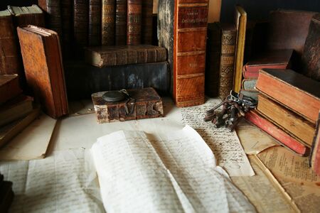 Antique workspace with old books and handwriting.の写真素材