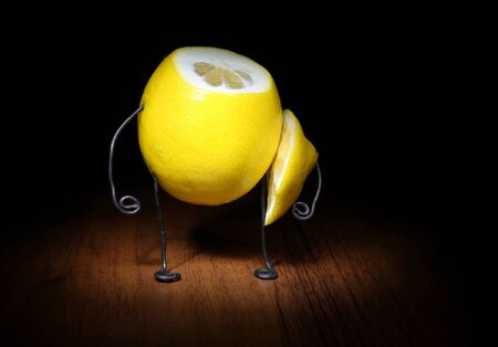 "Lemon Boy". Lemon with hands and feet of wire standing on wooden floorの写真素材