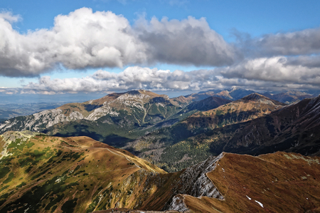 Autumn mountain view in the West Tatra. Clouds and blue sky. Great peaks.の写真素材