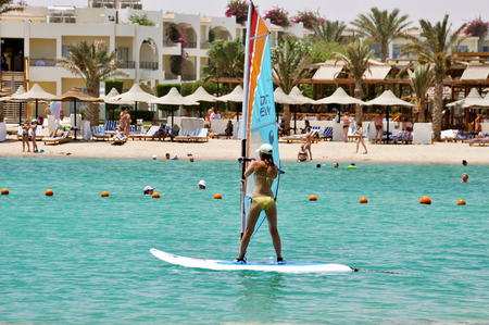 MAKADI BAY, EGYPT - JULY 9,2012: Girl windsurfs in the hotel in Makadi Bay. Egyptのeditorial素材