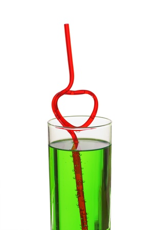 glass with green beverage and drinking strawの写真素材