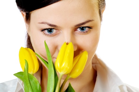 beautiful girl with smile smells yellow tulipsの写真素材