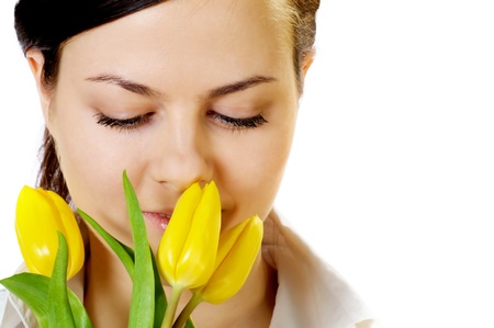 beautiful girl with smile smells yellow tulipsの写真素材