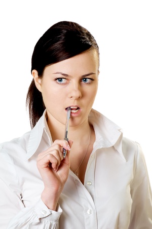 thoughtful serious business girl in white blouse with pen isolated on whiteの写真素材