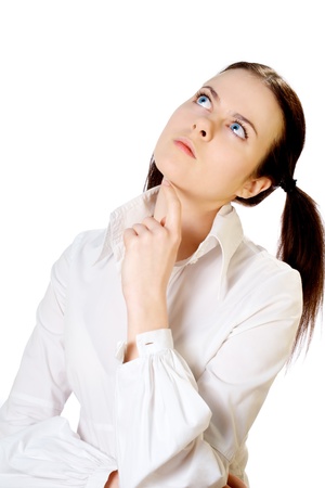 serious business girl in white blouse isolated on white looking upの写真素材