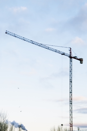 Building Crane Sihouette on Morning Sky with Cloudsの写真素材