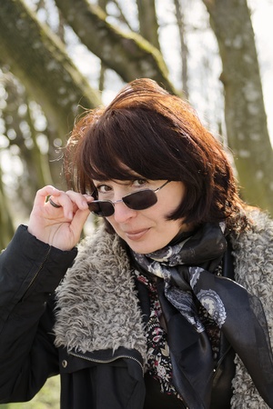 smile woman looks out because of sunglassesの写真素材