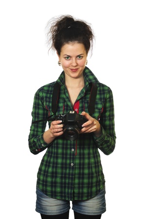 smiling young girl in green shirt with photo camera isolated on white backgroundの写真素材