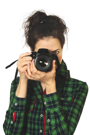 young girl in green shirt with photo camera isolated on white backgroundの写真素材