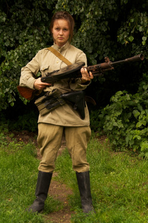 girl with gun on celebration of 750 anniversary of Guryevsk (Neuhausen O.P.) on June 30, 2012 in Guryevsk, Kaliningradskaya oblast, Russiaのeditorial素材