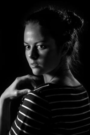 scared girl on black background, black and white imageの写真素材