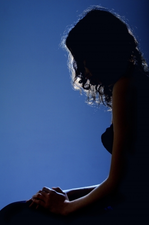 silhouette profile of woman sitting in moonlightの写真素材