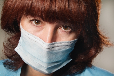 woman looks at camera in medical maskの写真素材
