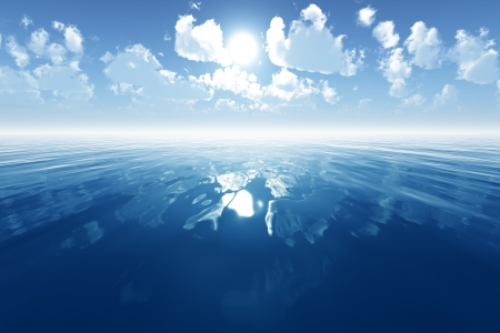 blue calm sea with reflected clouds on blue skyの写真素材