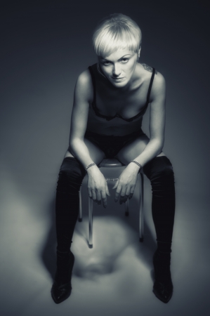 woman sitting looks at camera monochromeの写真素材