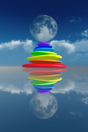 stacked rainbow colored stones in moonlight at water with reflections. の写真素材
