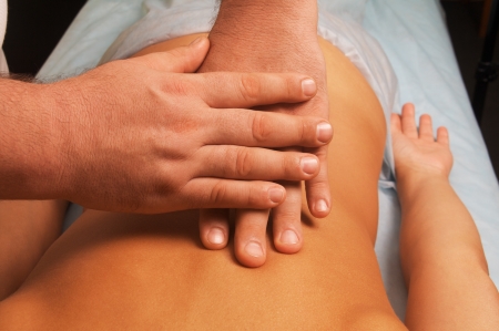 position of hands fingers at massage of a female bodyの写真素材