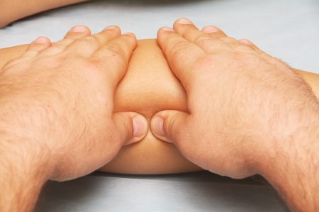 position of hands and fingers at massage of a female bodyの写真素材