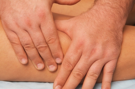 position of hands and fingers at massage of a female bodyの写真素材
