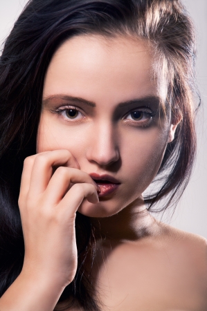 young brunette serious pretty girl close up portraitの写真素材