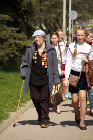 Kaliningrad, Russia - May 05, 2013 - mature woman veteran of the World War II with his medals walk at street on during the victory celebrationのeditorial素材