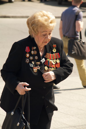 Kaliningrad, Russia - May 05, 2013 - woman veteran of the World War with medals walk at street on during the victory celebrationのeditorial素材