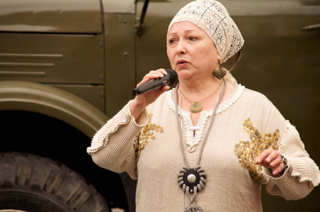 KALININGRAD, RUSSIA - JULY 14: woman in russian national dress sang and danced on the street on City Day of Kaliningrad celebration on July 14, 2013 in Kaliningrad, Russiaのeditorial素材