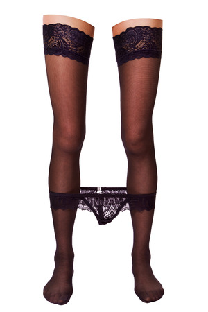 perfectly female feet in stockings with black panties on legs isolated on white backgroundの写真素材
