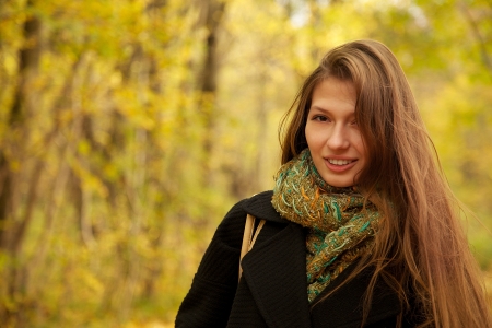 girl with long hairs smiling looks at cameraの写真素材