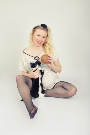 Pregnant Woman Plays with Cat and Coconutの写真素材
