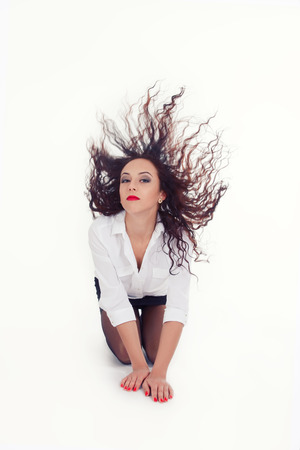 beauty girl plays with her long curly hairsの写真素材