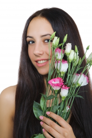 smiling shirtless girl with flowers looks at camera isolated on white backgroundの写真素材