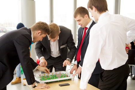 KALININGRAD, RUSSIA â MARCH 02, 2014: Businessmen plays in football table game on coffeebreakのeditorial素材