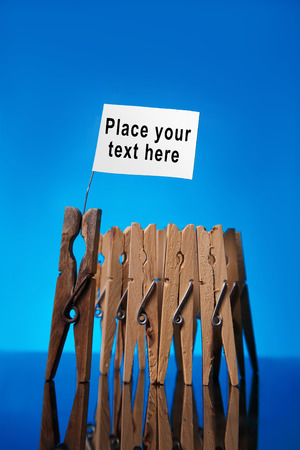 clothespin team with old leader and clean white flag with place for your text and symbolsの写真素材
