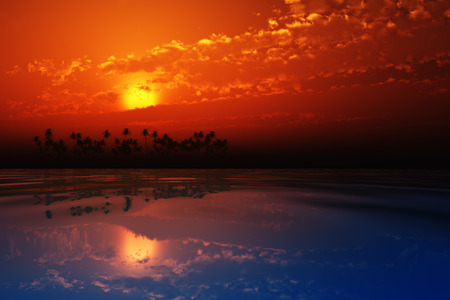 red sunset in clouds over coconut tropic islandの写真素材
