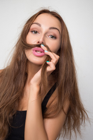 Fun Young Woman Using her hair as a Mustacheの写真素材