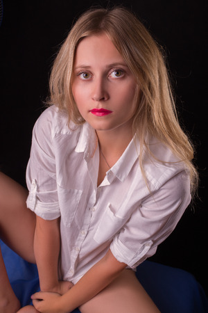 serious pretty blond girl looking upの写真素材