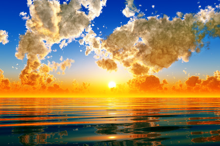 dramatic sunset in puffy clouds over seaの写真素材