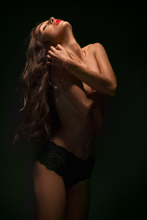 sensual topless woman on black backgroundの写真素材